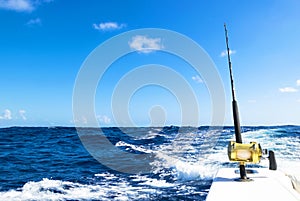Fishing rod in a saltwater boat during fishery day in blue ocean