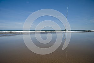 Fishing rod at the sand of the beach