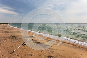 Fishing rod on a  sea beach
