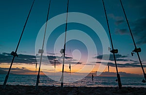 Fishing rod spinning. Fishing rods in rod due the fishery day at the sunset on sea. Rod rings. Fishing tackle. Fishing