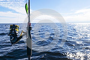 Fishing on the lake. Hands of fisherman with fishing rod. Macro shot. Fishing rod and hands of fisherman over lake water. Spinning