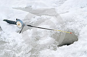 A fishing rod for winter fishing near the ice-hole