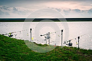 Fishing rods on the grass at the edge of the river