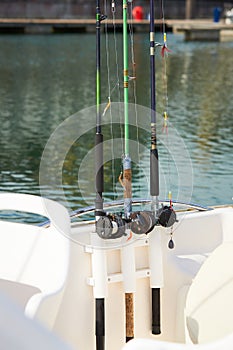 Fishing rods with hooks on the boat in natural setting. CloseupFishing rods with hooks on the boat in natural setting. Closeup