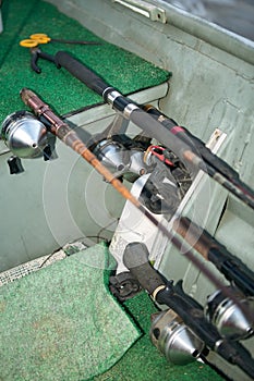 Fishing rods, reels and angling equipment in boat