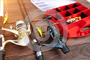 Fishing rods and tackle on a wooden background