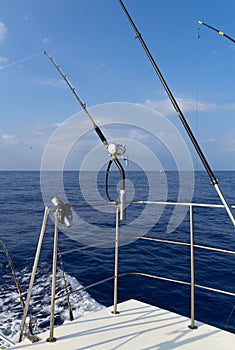 Fishing rods on upper and lower deck of boat