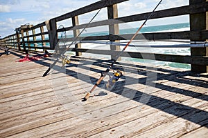 Fishing rods on a wooden marine jetty or pier
