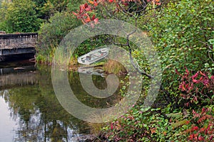 Fishing rowboat parked along the lake shore.