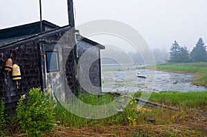 Fishing shack on tidewater inlet photo