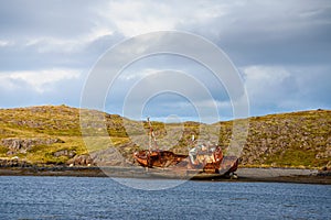 Fishing ship wreck laying on the Snaefellsnes peninsula in Iceland photo