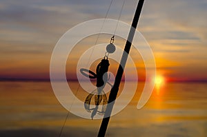 Fishing. Silhouette of tackles on sunset background