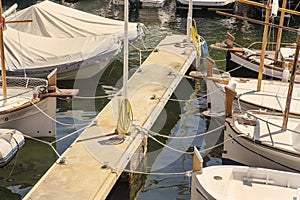 Fishing small white boats tied on a pier