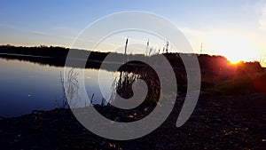 Fishing Spot at Early Morning Sunrise Beside Lake.  Best Secret Location and Time to Fish at Dawn With Calm Water