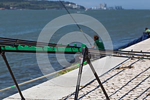 Fishing stand with angling rods on promenade