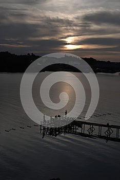 Fishing in the sunset under the orange sky