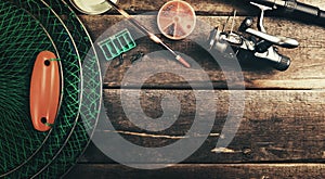 Fishing tackle angling equipment on wooden background with copy space