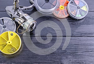 Fishing tackle on a dark wooden background