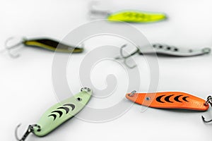 Fishing tackle in different colors on a white background