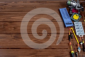 Fishing tackle - fishing rod fishing float and accessories on wooden background, copy space