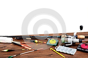 Fishing tackle - fishing rod fishing float and accessories on wooden background, copy space