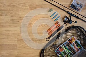 Fishing tackle flat lay on a wooden backround