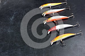 Fishing tackle - hooks and Wobblers on background