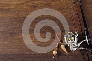 Fishing tackle on the wooden background