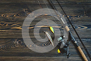 Fishing tackle on a wooden table. toned image