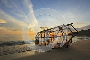 Fishing tool in thai style on beach which has view of beautiful sea and sky in morning as background
