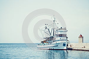 Fishing trawler in the beautiful harbor of a small town Postira - Croatia, island Brac