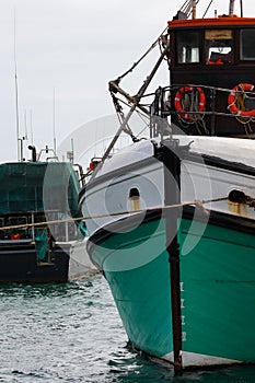 Fishing Trawler With Life Buoys In Harbor