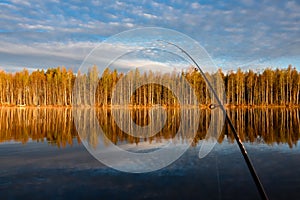 Fishing trip to TuusjÃ¤rvi. Calm lake,trees are mirrored from wa