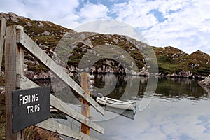 Fishing trips sign and scenic bay view photo