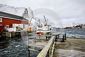 Fishing vessel at the pier of traditional fishing settlements of Lofoten islands. Beautiful Norway landscape.