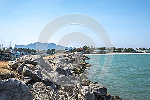 Fishing village at rock dam on the beach