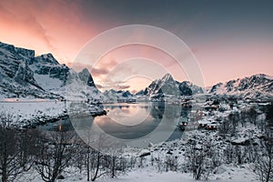 Fishing village in snow mountain with sunset sky at coastline