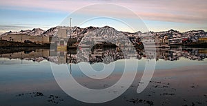 Fishing village in Southern Iceland with mountains and reflections