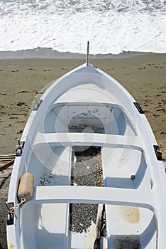 Fishing wooden boat moored on the beach