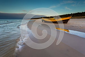 A fishing wooden boat moored by the beach, Debki, Poland