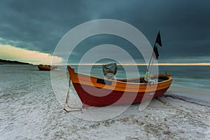 A fishing wooden boat moored by the beach, Debki, Poland