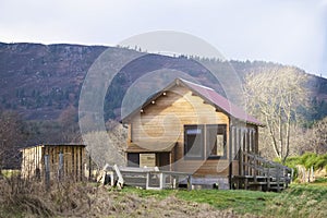 Fishing wooden shelter hut and log store on river dee Scotland for fisherman and anglers