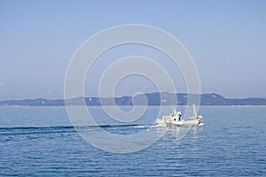 Fishingboat sail in blue sea