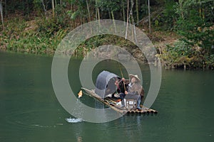 Fishman catching fish in canoe
