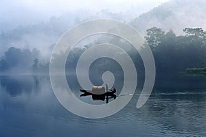 Fishman in the fog river