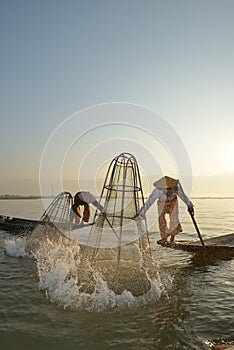 Fishman and net in Canoe sunrise