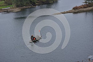 Fishman rowing boat in canoe Lantern