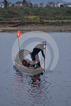 Fishman rowing boat in canoe Lantern