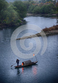 Fishman rowing boat in canoe Lantern