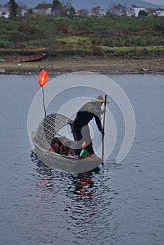 Fishman rowing boat in canoe Lantern photo